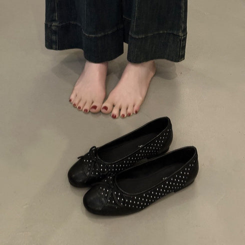 Black slip-on ballet flats with bow and dotted cutouts