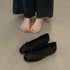 Black slip-on ballet flats with bow and dotted cutouts