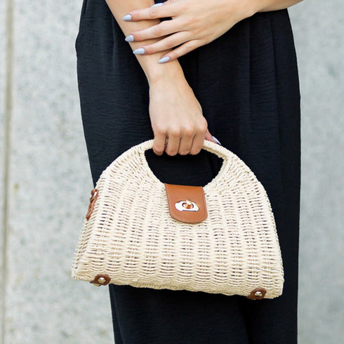 Straw-color Stella purse carried by the top handle