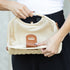 Open interior and fabric lining of Stella woven straw purse