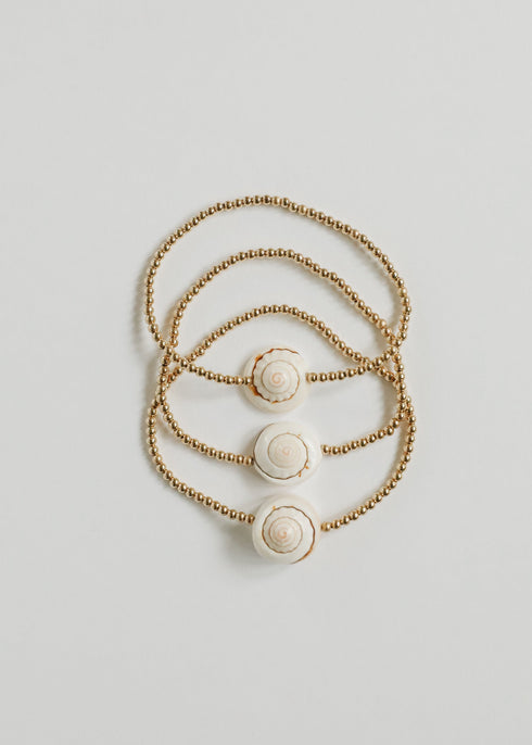 Three CanyonLeaf gold-filled conch-shell pieces shown together; listing includes one selected piece