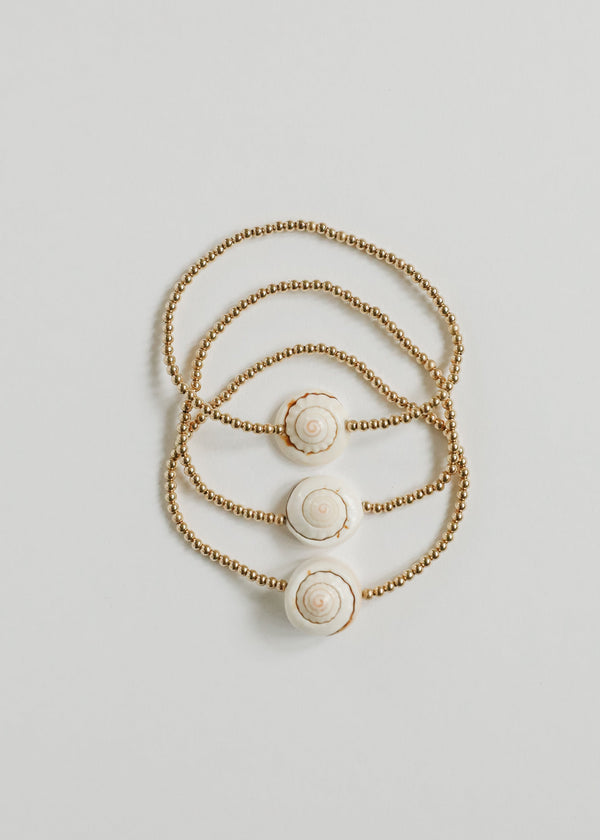 Three CanyonLeaf gold-filled conch-shell pieces shown together; listing includes one selected piece