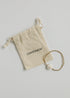 Single CanyonLeaf conch-shell stretch bracelet beside a branded drawstring pouch