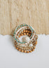 CanyonLeaf conch-shell bracelet styled in a mixed jewelry stack