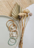 Conch-shell and gold-filled beaded jewelry arranged with coordinating bracelets