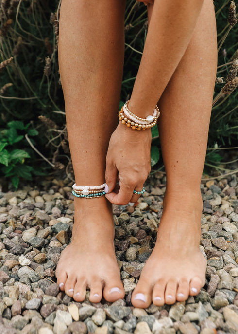 CanyonLeaf conch-shell jewelry worn on a wrist and ankle with other pieces for styling