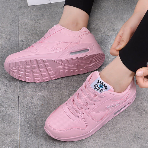 Pink platform sneakers showing textured outsole and lace-up front
