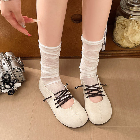 Top view of beige low-cut flats with contrasting dark laces
