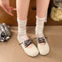 Top view of beige low-cut flats with contrasting dark laces