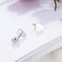 Sterling silver heart stud earrings showing one heart face and one post with butterfly back