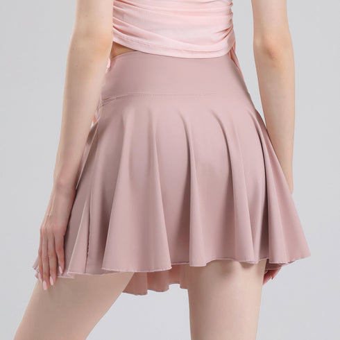 Pink pleated tennis skort angled view on model