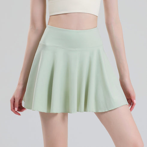 Green pleated tennis skort front view on model