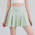 Green pleated tennis skort front view on model