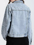 Rear view of light-blue denim jacket showing shoulder trim