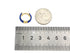 Cobalt enamel hoop earring beside a coin and ruler for scale