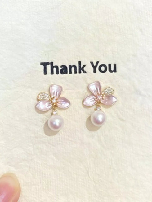 Pair of flower earrings with synthetic pearl drops on a white display card