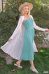 Ivory open-front mesh cardigan worn over a turquoise dress outdoors
