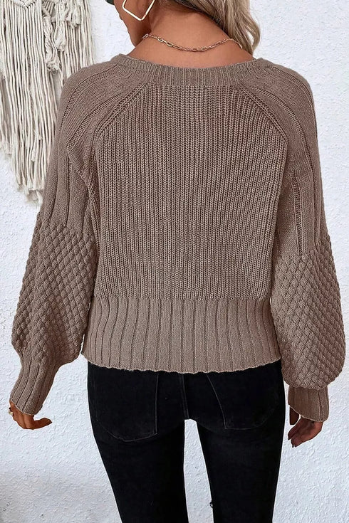 Back of taupe knit cardigan with ribbed hem and cuffs