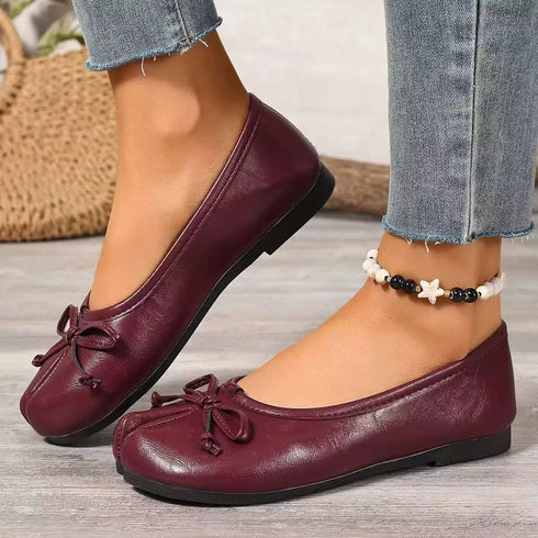 Angled front view of burgundy split-toe bow flats