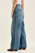 Side view of vintage indigo Wilhelmina baggy jeans and their wide-leg shape