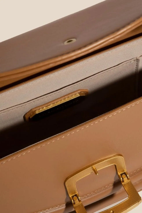 Close-up of camel faux leather bag flap and interior opening