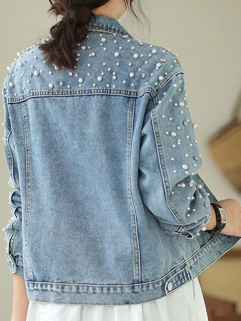 Back view of light-blue jacket with beads across shoulders and sleeves