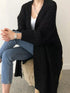 Black open-front cardigan showing long sleeves and ribbed cuffs