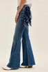 Side profile of medium-wash flares showing the wide leg opening