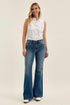 Full-length outfit view of Judy Blue flares with a white top