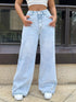 Front view of light blue jeans showing the waistband and wide legs