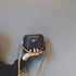 Black mini bucket bag with gold-tone button and long strap