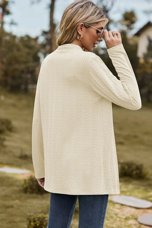 Back view of cream long cardigan showing its textured fabric