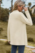 Back view of cream long cardigan showing its textured fabric