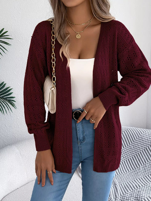 Burgundy crochet-knit cardigan, seated view with the open front visible