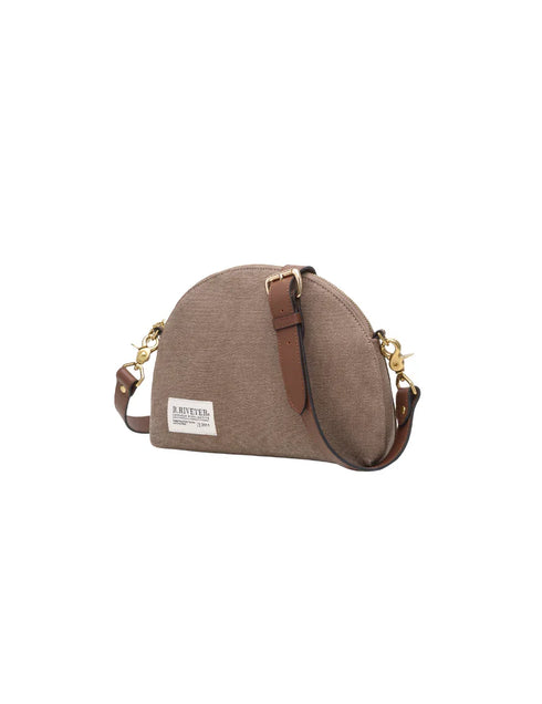 Hopper crossbody angled to show the adjustable brown leather strap