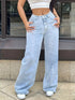 Light blue high-waisted jeans worn with both hands resting at the hips