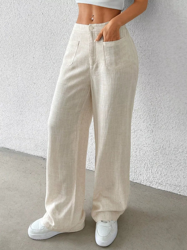 Cream high-waisted wide-leg pants worn with a white cropped top, angled front view showing patch pocket