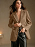 Light neutral notch-lapel blazer shown open over black trousers