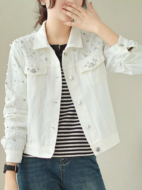 Closer front view of white jacket with decorative beads and buttons