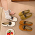 Beige lace-up flats worn with white socks beside green and brown pairs
