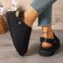 Side and rear view of black clogs showing heel strap and sole