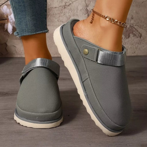 Gray clogs in an angled front view with heel strap visible