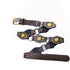 Brown studded belt laid out on white, showing buckle, linked panels and long end