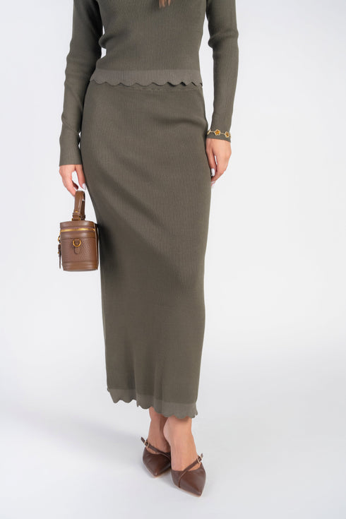Olive rib-knit maxi skirt showing the scalloped hem, front view