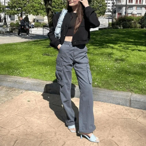 Blue-gray cargo pants styled with a black jacket outdoors