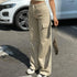 Beige cargo pants showing button fastening and thigh pockets