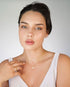 Front view of model wearing butterfly studs and a butterfly necklace
