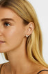 Close-up of a butterfly stud worn on an ear