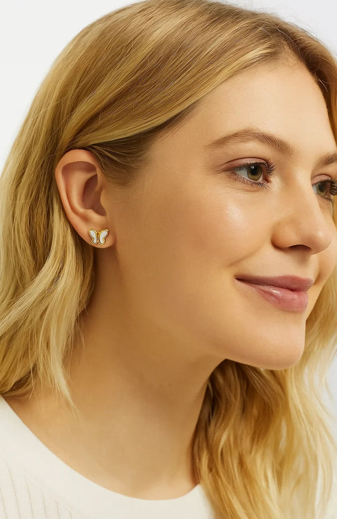 Butterfly studs worn with a cream top
