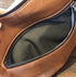 Close-up of an interior zip pocket and dark fabric lining